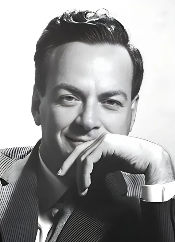 Richard Feynman resting his chin on his hand, in a suit and striped shirt, smiling. Black and white.